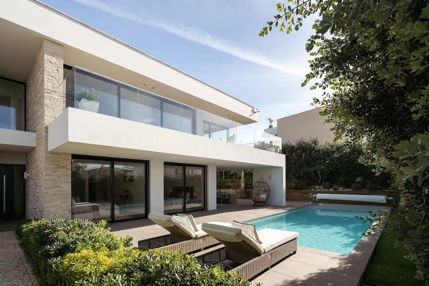 Modern white villa with a private pool and garden terrace