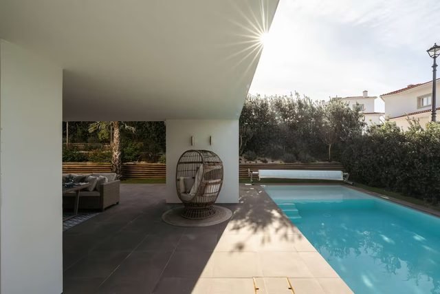 Pool and covered terrace in the afternoon sun